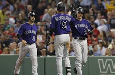 May 26, 2016; Boston, MA, USA; Colorado Rockies catcher Dustin Garneau (13) is congratulated after hitting a two run homer against the Boston Red Sox in the fifth inning at Fenway Park. Mandatory Credit: David Butler II-USA TODAY Sports