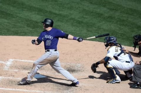 May 4, 2016; San Diego, CA, USA; Colorado Rockies third baseman Mark Reynolds (12) singles during the ninth inning against the San Diego Padres at Petco Park. Mandatory Credit: Jake Roth-USA TODAY Sports