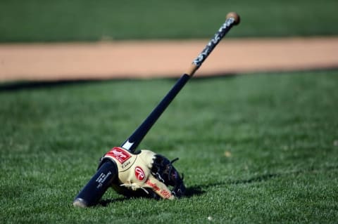 Feb 25, 2016; Glendale, AZ, USA; A bat and mitt sit on the field during a Chicago White Sox workout at Camelback Ranch Practice Fields. Mandatory Credit: Joe Camporeale-USA TODAY Sports