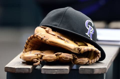 May 10, 2015; Denver, CO, USA; General view of a Colorado Rockies glove and hat during the seventh inning of the game against the Los Angeles Dodgers at Coors Field. The Dodgers defeated the Rockies 9-5. Mandatory Credit: Ron Chenoy-USA TODAY Sports