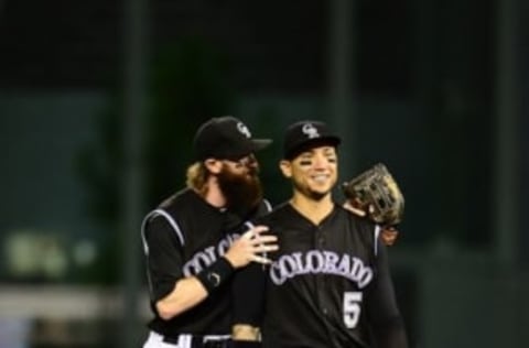 Jul 21, 2016; Denver, CO, USA; Colorado Rockies center fielder Charlie Blackmon (19) and right fielder Carlos Gonzalez (5) celebrate the win over the Atlanta Braves at Coors Field. The Rockies defeated the Braves 7-3. Mandatory Credit: Ron Chenoy-USA TODAY Sports