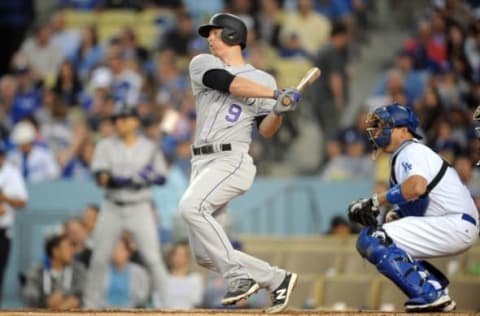 June 8, 2016; Los Angeles, CA, USA; Colorado Rockies second baseman DJ LeMahieu (9) hits a single in the fourth inning against Los Angeles Dodgers at Dodger Stadium. Mandatory Credit: Gary A. Vasquez-USA TODAY Sports