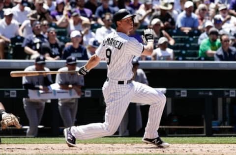 Jun 15, 2016; Denver, CO, USA; Colorado Rockies second baseman DJ LeMahieu (9) hits a double in the third inning against the New York Yankees at Coors Field. Mandatory Credit: Isaiah J. Downing-USA TODAY Sports