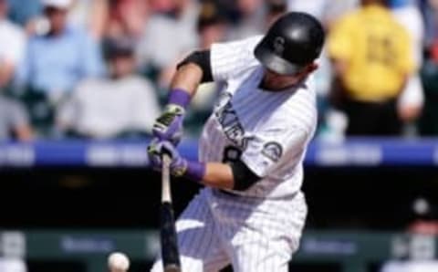 Jun 9, 2016; Denver, CO, USA; Colorado Rockies right fielder Gerardo Parra (8) hits a single in the third inning against the Pittsburgh Pirates at Coors Field. Mandatory Credit: Isaiah J. Downing-USA TODAY Sports