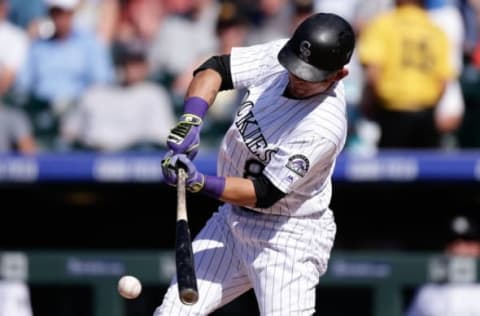 Jun 9, 2016; Denver, CO, USA; Colorado Rockies right fielder Gerardo Parra (8) hits a single in the third inning against the Pittsburgh Pirates at Coors Field. Mandatory Credit: Isaiah J. Downing-USA TODAY Sports