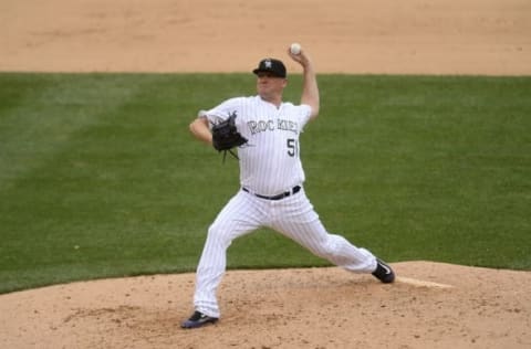 Jul 20, 2016; Denver, CO, USA; Colorado Rockies relief pitcher Jake McGee (51) delivers a pitch in the eighth inning against the Tampa Bay Rays at Coors Field. The Rays defeated the Rockies 11-3. Mandatory Credit: Ron Chenoy-USA TODAY Sports