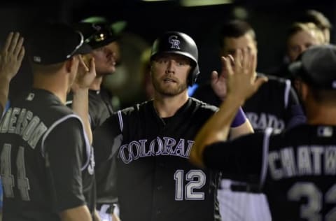 Jul 7, 2016; Denver, CO, USA; Colorado Rockies first baseman Mark Reynolds (12) celebrates scoring a run in the seventh inning against the Philadelphia Phillies at Coors Field. The Rockies defeated the Phillies 11-2. Mandatory Credit: Ron Chenoy-USA TODAY Sports