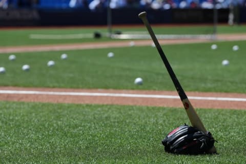 Jun 22, 2016; Toronto, Ontario, CAN; A bat rests inside a baseball glove at an MLB game between the Toronto Blue Jays and the Arizona Diamondbacks at Rogers Centre. Mandatory Credit: Kevin Sousa-USA TODAY Sports