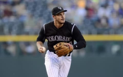 Jul 7, 2016; Denver, CO, USA; Colorado Rockies third baseman Nolan Arenado (28) prepares to throw to first base to end the first inning against the Philadelphia Phillies at Coors Field. Mandatory Credit: Ron Chenoy-USA TODAY Sports