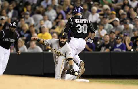 Sep 23, 2015; Denver, CO, USA; Colorado Rockies catcher Tom Murphy (30) runs out a single on Pittsburgh Pirates first baseman Pedro Alvarez (24) in the fourth inning Coors Field. Mandatory Credit: Ron Chenoy-USA TODAY Sports