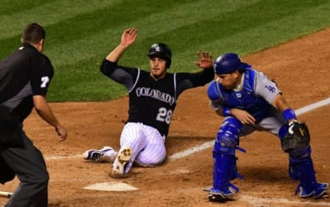 Aug 3, 2016; Denver, CO, USA; Los Angeles Dodgers catcher A.J. Ellis (17) is unable to tag out Colorado Rockies third baseman Nolan Arenado (28) for a run scored in the six inning at Coors Field. Mandatory Credit: Ron Chenoy-USA TODAY Sports