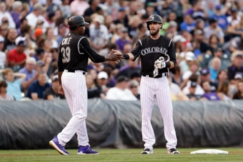 Aug 6, 2016; Denver, CO, USA; Colorado Rockies left fielder David Dahl (26) celebrates with third base coach Stu Cole (39) after hitting a triple in the second inning against the Miami Marlins at Coors Field. Mandatory Credit: Isaiah J. Downing-USA TODAY Sports