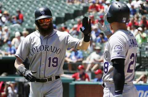 Aug 11, 2016; Arlington, TX, USA; Colorado Rockies center fielder Charlie Blackmon (19) is congratulated by third baseman Nolan Arenado (28) after hitting a home run in the first inning against the Texas Rangers at Globe Life Park in Arlington. Mandatory Credit: Tim Heitman-USA TODAY Sports