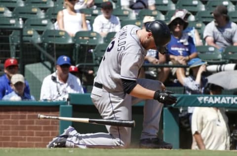 Aug 11, 2016; Arlington, TX, USA; Colorado Rockies first baseman Mark Reynolds (12) is injured after a swing in the seventh inning against the Texas Rangers at Globe Life Park in Arlington. Colorado Rockies won 12-9.Mandatory Credit: Tim Heitman-USA TODAY Sports