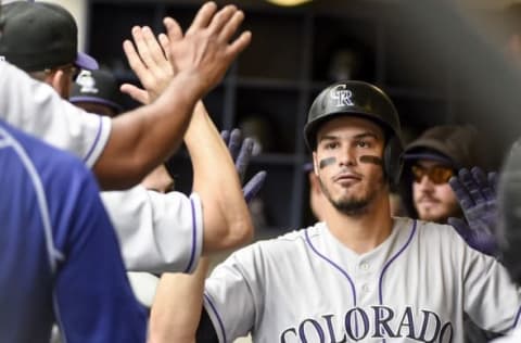 Aug 24, 2016; Milwaukee, WI, USA; Colorado Rockies third baseman Nolan Arenado (28) is greeted in the dugout after hitting a solo home run in the first inning during the game against the Milwaukee Brewers at Miller Park. Mandatory Credit: Benny Sieu-USA TODAY Sports