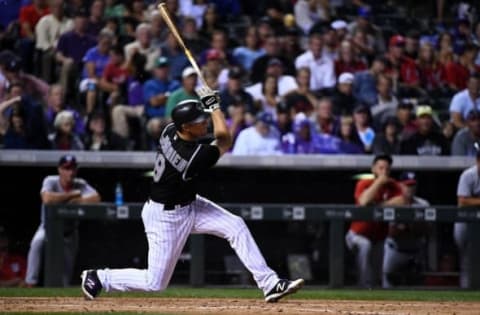 Aug 16, 2016; Denver, CO, USA; Colorado Rockies second baseman DJ LeMahieu (9) hits a two run home run in the third inning against the Washington Nationals at Coors Field. Mandatory Credit: Ron Chenoy-USA TODAY Sports