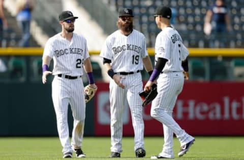 Aug 31, 2016; Denver, CO, USA; Colorado Rockies left fielder David Dahl (26) and center fielder Charlie Blackmon (19) and right fielder Carlos Gonzalez (5) congratulate each other following the game against the Los Angeles Dodgers at Coors Field. The Rockies defeated the Dodgers 7-0. Mandatory Credit: Isaiah J. Downing-USA TODAY Sports