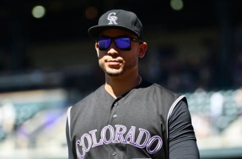 Sep 5, 2016; Denver, CO, USA; Colorado Rockies right fielder Carlos Gonzalez (5) walks back to the dugout second inning against the San Francisco Giants at Coors Field. Mandatory Credit: Ron Chenoy-USA TODAY Sports