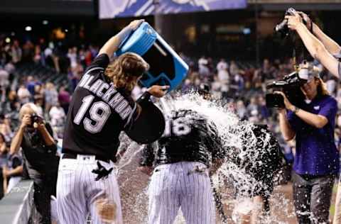 Sep 7, 2016; Denver, CO, USA; Colorado Rockies center fielder Charlie Blackmon (19) dumps water over pinch hitter Cristhian Adames (18) during an interview following the game against the San Francisco Giants at Coors Field. Mandatory Credit: Isaiah J. Downing-USA TODAY Sports