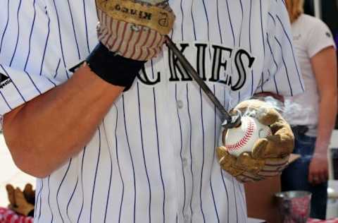 Apr 10, 2015; Denver, CO, USA; General view of used baseballs being branded outside of Coors Field before the start of the game against the Chicago Cubs. Mandatory Credit: Ron Chenoy-USA TODAY Sports