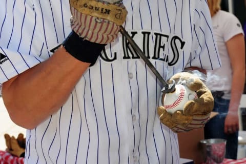 Apr 10, 2015; Denver, CO, USA; General view of used baseballs being branded outside of Coors Field before the start of the game against the Chicago Cubs. Mandatory Credit: Ron Chenoy-USA TODAY Sports