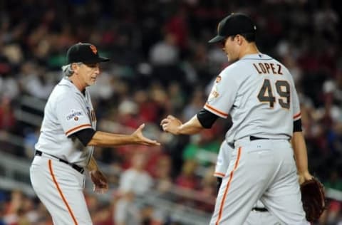 Jul 5, 2015; Washington, DC, USA; San Francisco Giants pitcher Javier Lopez (49) is taken out of the game by bench coach Ron Wotus (10) in the eighth inning against the Washington Nationals at Nationals Park. Mandatory Credit: Evan Habeeb-USA TODAY Sports