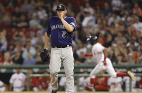 May 26, 2016; Boston, MA, USA; Colorado Rockies relief pitcher Jake McGee (51) watches the ball as Boston Red Sox left fielder Chris Young (30) runs the bases hitting a double in the ninth inning at Fenway Park. Colorado defeated the Red Sox 8-2. Mandatory Credit: David Butler II-USA TODAY Sports