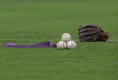 Jul 20, 2016; Philadelphia, PA, USA; Baseballs and a stretching band and a glove on the field prior to action between the Philadelphia Phillies and the Miami Marlins at Citizens Bank Park. Philadelphia won 4-1. Mandatory Credit: Bill Streicher-USA TODAY Sports