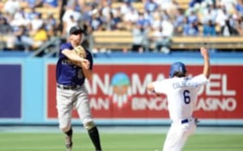 September 25, 2016; Los Angeles, CA, USA; Colorado Rockies second baseman DJ LeMahieu (9) throws to first in the sixth inning as Los Angeles Dodgers second baseman Charlie Culberson (6) is out at second at Dodger Stadium. Mandatory Credit: Gary A. Vasquez-USA TODAY Sports