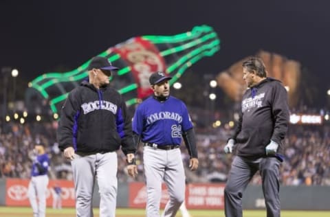 Sep 29, 2016; San Francisco, CA, USA; Colorado Rockies manager Walt Weiss (22) walks back to the dugout after checking on Colorado Rockies starting pitcher Jon Gray (55) during the sixth inning against the San Francisco Giants at AT&T Park. Mandatory Credit: Neville E. Guard-USA TODAY Sports