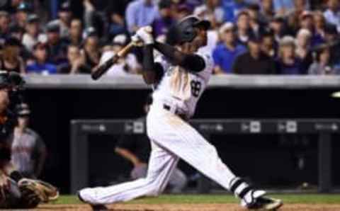 Sep 6, 2016; Denver, CO, USA; Colorado Rockies left fielder Raimel Tapia (68) hits a sacrifce fly to score a run in the fifth inning against the San Francisco Giants at Coors Field. The Giants defeated the Rockies 3-2. Mandatory Credit: Ron Chenoy-USA TODAY Sports