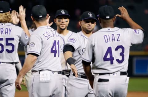 PHOENIX, AZ – JULY 20: Gerardo Parra #8 of the Colorado Rockies (C) is congratulated by coaches Jeff Salazar #41 and Tony Diaz #43 after a 11-10 victory against the Arizona Diamondbacks during an MLB game at Chase Field on July 20, 2018 in Phoenix, Arizona. (Photo by Ralph Freso/Getty Images)