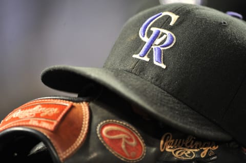 DENVER – MAY 25: A hat and glove of the Colorado Rockies rests in the dugout during the game against the Arizona Diamondbacks at Coors Field on May 25, 2010 in Denver, Colorado. (Photo by Garrett W. Ellwood/Getty Images)