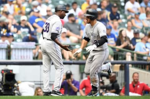 MILWAUKEE, WI – AUGUST 05: Nolan Arenado #28 of the Colorado Rockies is congratulated by third base coach Stu Cole #39 following a solo home run during the eleventh inning of a game at Miller Park on August 5, 2018 in Milwaukee, Wisconsin. (Photo by Stacy Revere/Getty Images)