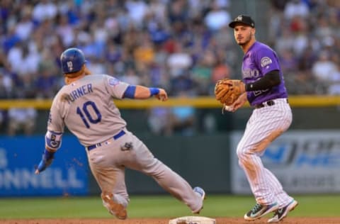 DENVER, CO – AUGUST 10: Nolan Arenado #28 of the Colorado Rockies sets to throw to first to complete a third inning double play after forcing out Justin Turner #10 of the Los Angeles Dodgers at Coors Field on August 10, 2018 in Denver, Colorado. (Photo by Dustin Bradford/Getty Images)