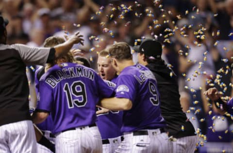 DENVER, CO – AUGUST 11: Teammates mob Ryan McMahon #24 of the Colorado Rockies as he crosses home plate after a walk-off, three-run home run against the Los Angeles Dodgers at Coors Field on August 11, 2018 in Denver, Colorado. Colorado won 3-2. (Photo by Joe Mahoney/Getty Images)