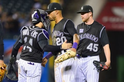 DENVER, CO – AUGUST 22: Tony Wolters #14, Ian Desmond #20, and Scott Oberg #45 of the Colorado Rockies celebrate after a 6-2 win over the San Diego Padres at Coors Field on August 22, 2018 in Denver, Colorado. (Photo by Dustin Bradford/Getty Images)