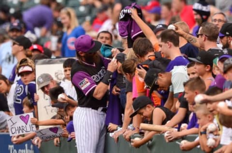 DENVER, CO – AUGUST 24: Charlie Blackmon #19 of the Colorado Rockies signs autographs for fans before a game against the San Diego Padres during Players Weekend at Coors Field on August 24, 2018 in Denver, Colorado. Players are wearing special jerseys with their nicknames on them during Players’ Weekend. (Photo by Dustin Bradford/Getty Images)