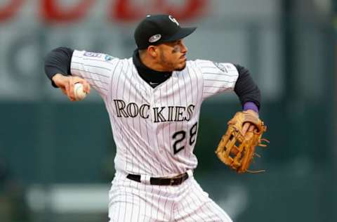 DENVER, CO – OCTOBER 07: Nolan Arenado #28 of the Colorado Rockies throws out Travis Shaw #21 of the Milwaukee Brewers in the fourth inning of Game Three of the National League Division Series against the Milwaukee Brewers at Coors Field on October 7, 2018 in Denver, Colorado. (Photo by Justin Edmonds/Getty Images)