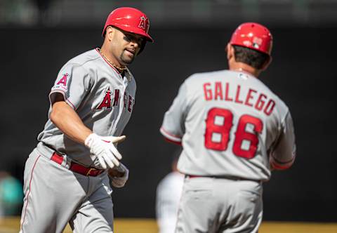 SEATTLE, WA – JUNE 01: Albert Pujols #5 of the Los Angeles Angels of Anaheim is congratulated by third base coach Mike Gallego after hitting a home run during a game against the Seattle Mariners at T-Mobile Park on June 1, 2019 in Seattle, Washington. The Angels won the game 6-3. (Photo by Stephen Brashear/Getty Images)