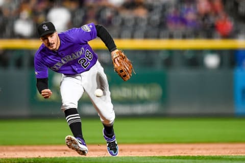 DENVER, CO – JULY 13: Nolan Arenado #28 of the Colorado Rockies reaches to make a barehanded defensive play in the first inning of a game against the Cincinnati Reds at Coors Field on July 13, 2019 in Denver, Colorado. (Photo by Dustin Bradford/Getty Images)