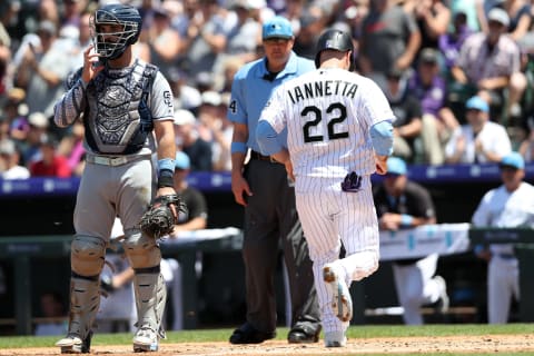 DENVER, COLORADO – JUNE 16: Chris Iannetta #22 of the Colorado Rockies scores on a fielding error on a hit by Charlie Blackmon in the first inning against the San Diego Padres at Coors Field on June 16, 2019 in Denver, Colorado. (Photo by Matthew Stockman/Getty Images)