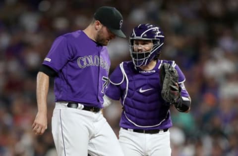 DENVER, COLORADO – JUNE 29: Pitcher Wade Davis and catcher Tony Wolters #14 of the Colorado Rockies confer in the ninth inning against the Los Angeles Dodgers at Coors Field on June 29, 2019 in Denver, Colorado. (Photo by Matthew Stockman/Getty Images)