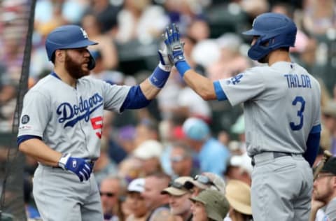 DENVER, COLORADO – JUNE 30: Russell Martin #55 of the Los Angeles Dodgers is congratulated by Chris Tayler #3 after scoring on a Joc Pederson 2 RBI single in the sixth inning against the Colorado Rockies at Coors Field on June 30, 2019 in Denver, Colorado. (Photo by Matthew Stockman/Getty Images)