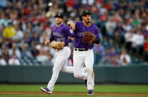 DENVER, CO – AUGUST 28: Third baseman Nolan Arenado #28 of the Colorado Rockies throws to first base for the third out of the second inning as Trevor Story #27 looks on against the Boston Red Sox at Coors Field on August 28, 2019 in Denver, Colorado. (Photo by Justin Edmonds/Getty Images)