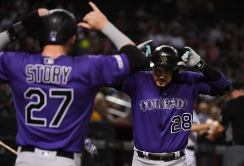 PHOENIX, ARIZONA – AUGUST 20: Nolan Arenado #28 of the Colorado Rockies celebrates with Trevor Story #27 after Arenado’s two-run home run off of Alex Young of the Arizona Diamondbacks during the fourth inning at Chase Field on August 20, 2019 in Phoenix, Arizona. Arenado was playing in his 1,000th MLB game. (Photo by Norm Hall/Getty Images)