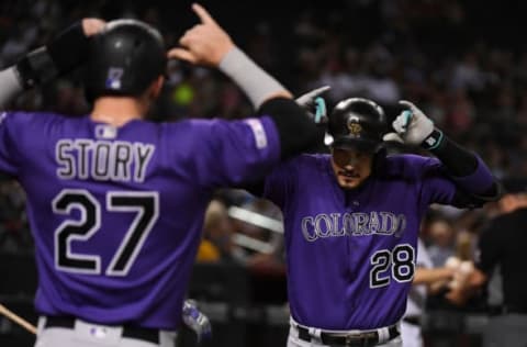 PHOENIX, ARIZONA – AUGUST 20: Nolan Arenado #28 of the Colorado Rockies celebrates with Trevor Story #27 after Arenado’s two-run home run off of Alex Young of the Arizona Diamondbacks during the fourth inning at Chase Field on August 20, 2019 in Phoenix, Arizona. Arenado was playing in his 1,000th MLB game. (Photo by Norm Hall/Getty Images)