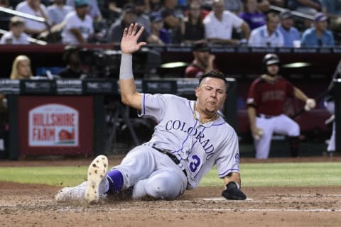 PHOENIX, ARIZONA – AUGUST 21: Yonathan Daza #31 of the Colorado Rockies safely slides home to score against the Arizona Diamondbacks in the fourth inning of the MLB game at Chase Field on August 21, 2019 in Phoenix, Arizona. (Photo by Jennifer Stewart/Getty Images)