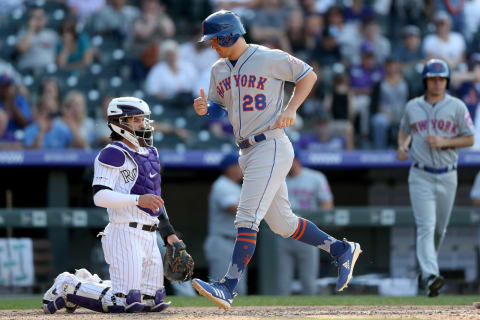 DENVER, COLORADO – SEPTEMBER 18: J.D. Davis #28 of the New York Mets scores the go ahead run after Pete Alonso is walked with the bases loaded in the ninth inning against the Colorado Rockies at Coors Field on September 18, 2019 in Denver, Colorado. (Photo by Matthew Stockman/Getty Images)