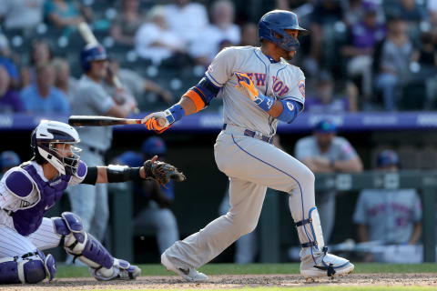 DENVER, COLORADO – SEPTEMBER 18: Robinson Cano #24 of the New York Mets hits a RBI ground out in the ninth inning against the Colorado Rockies at Coors Field on September 18, 2019 in Denver, Colorado. (Photo by Matthew Stockman/Getty Images)